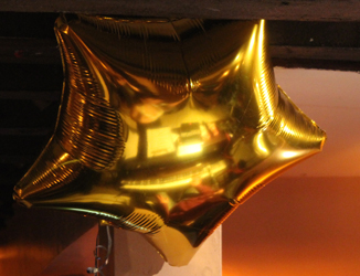 Sarah Lark and Nathan Martin reflected in a birthday balloon